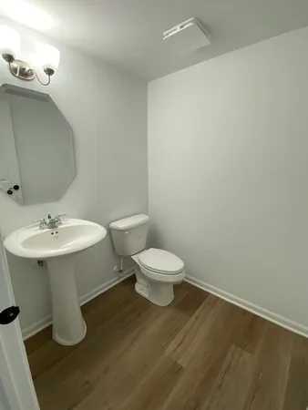 a bathroom with a sink toilet and a mirror