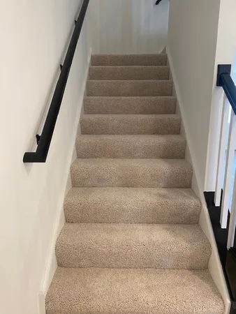 a view of staircase with white walls