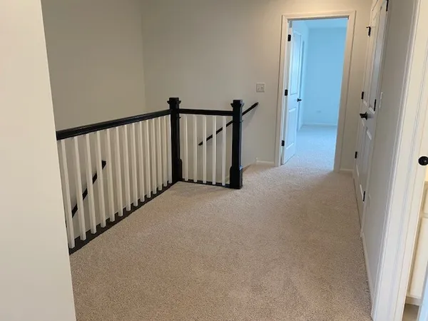 a view of a hallway with staircase