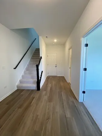 a view of an entryway with wooden floor