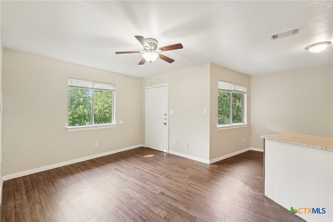 1634 Post Road, Unit 4 San Marcos, TX 78666 - Photo 6 of 11 a view of an empty room with wooden floor and a window