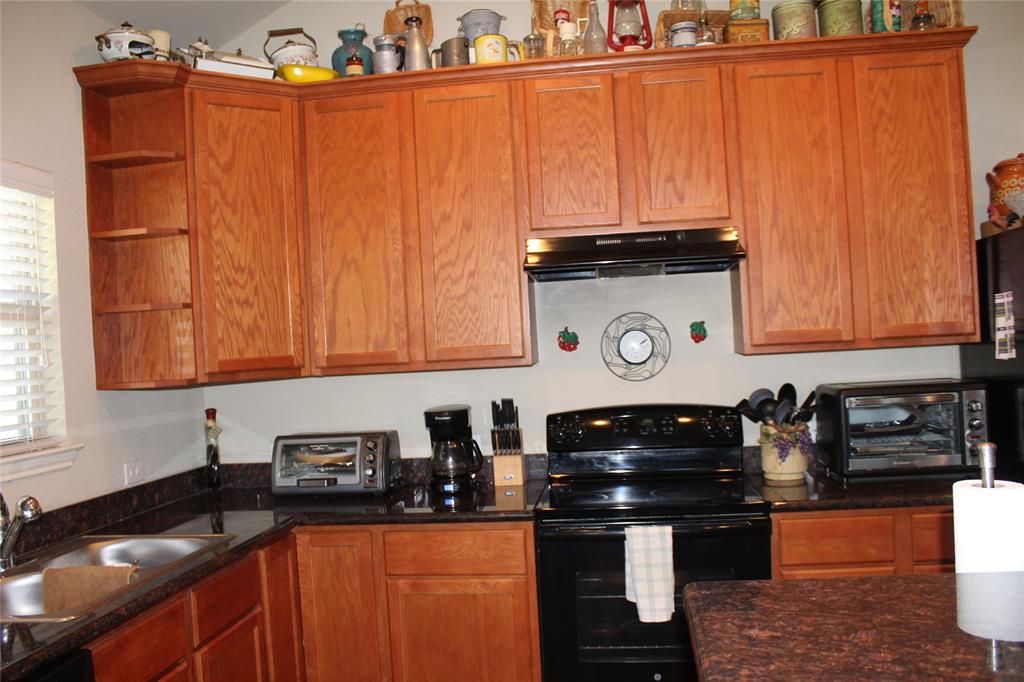 10717 Fallbrook Road Waco, TX 76708 - Photo 13 of 33 a kitchen with stainless steel appliances granite countertop a stove and a sink