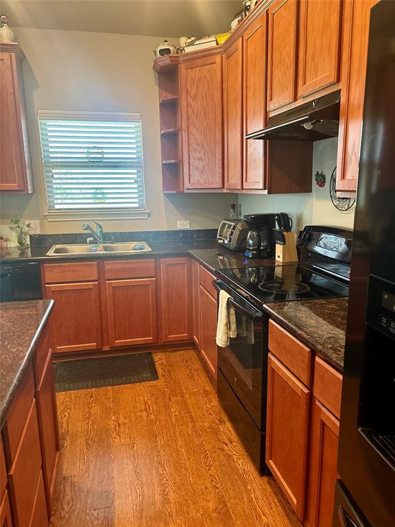 10717 Fallbrook Road Waco, TX 76708 - Photo 14 of 33 a kitchen with stainless steel appliances granite countertop a sink stove and microwave