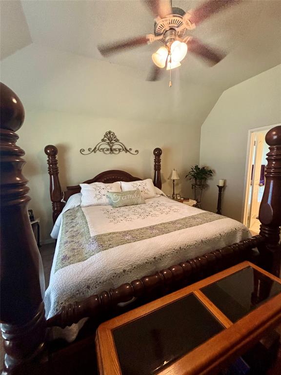 10717 Fallbrook Road Waco, TX 76708 - Photo 18 of 33 a bedroom with a bed and a chandelier