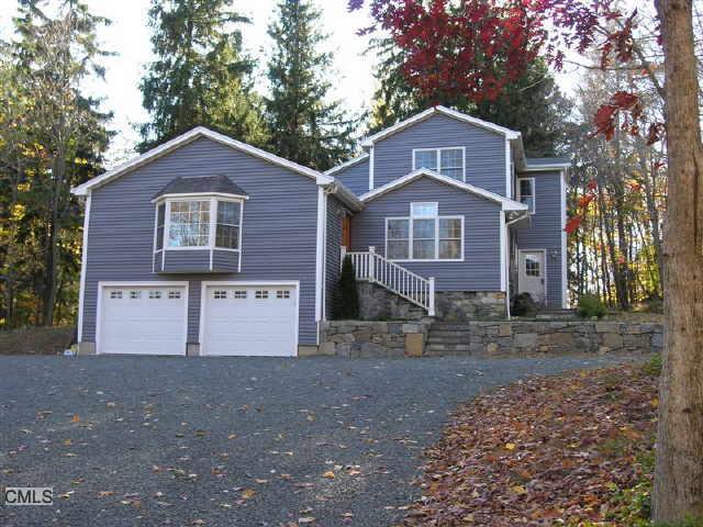 9 Scott Ridge Road Ridgefield, CT 06877 - Photo 1 of 1 a front view of a house with a yard
