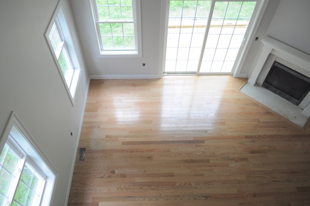 12 B Trail Ridge Way, Unit 12B Harvard, MA 01451 - Photo 10 of 20 a view of an empty room with wooden floor and a window