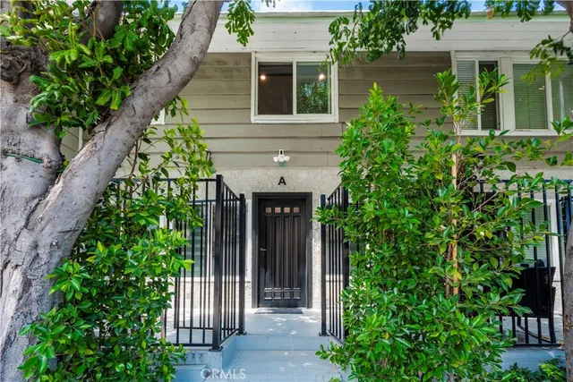 an entrance to house with yard and green space