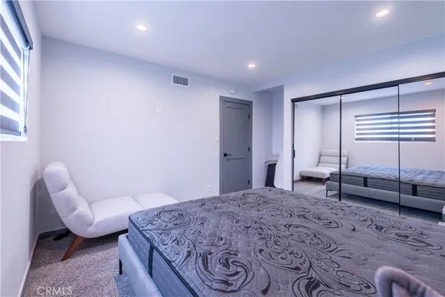 a bedroom with a bed and a couch