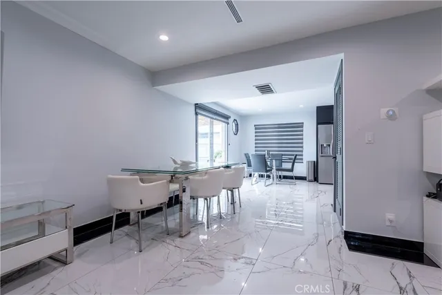 a kitchen with stainless steel appliances granite countertop a sink and a refrigerator