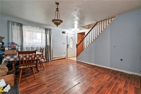 a view of a room with wooden floor windows and stairs