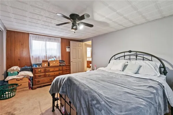 a bedroom with a bed and large window