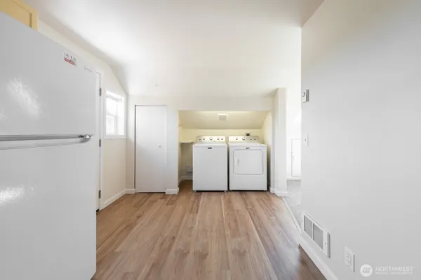 a view of a room with wooden floor and a bathroom