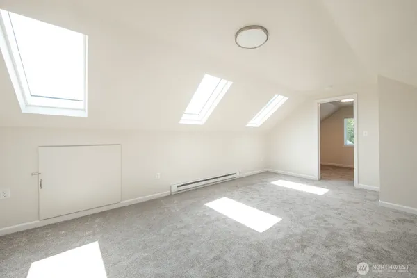 an empty room with windows and entrance