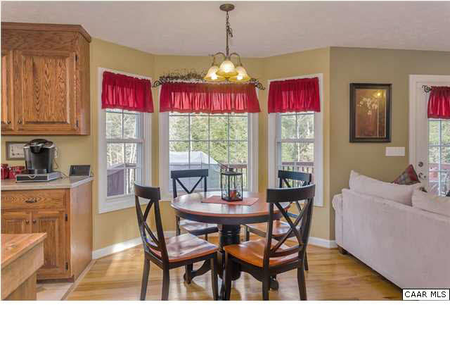 686 Valley View Road Ruckersville, VA 22968 - Photo 24 of 33 a dining room with furniture a chandelier and wooden floor