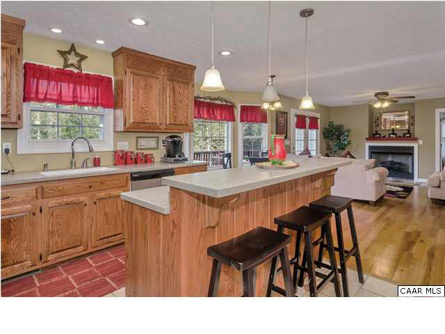 686 Valley View Road Ruckersville, VA 22968 - Photo 25 of 33 a kitchen with kitchen island granite countertop a sink cabinets and window