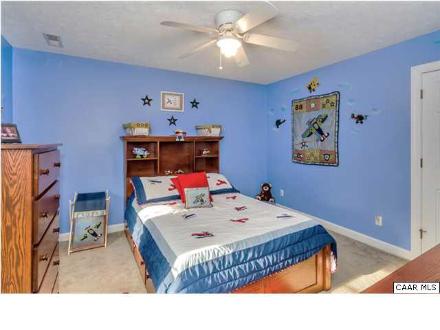 686 Valley View Road Ruckersville, VA 22968 - Photo 9 of 33 a bedroom with a bed and a chandelier