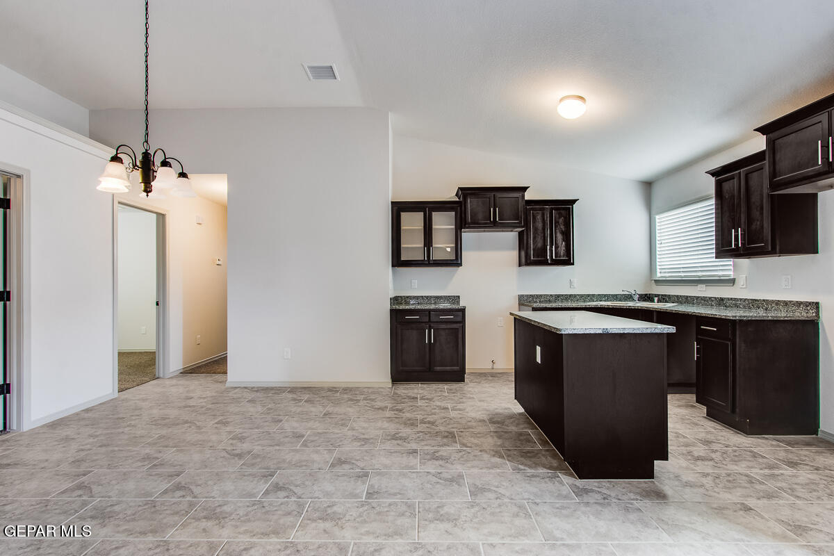 12420 Oconee Place Clint, TX 79836 - Photo 9 of 27 a kitchen with stainless steel appliances granite countertop a refrigerator and a stove top oven