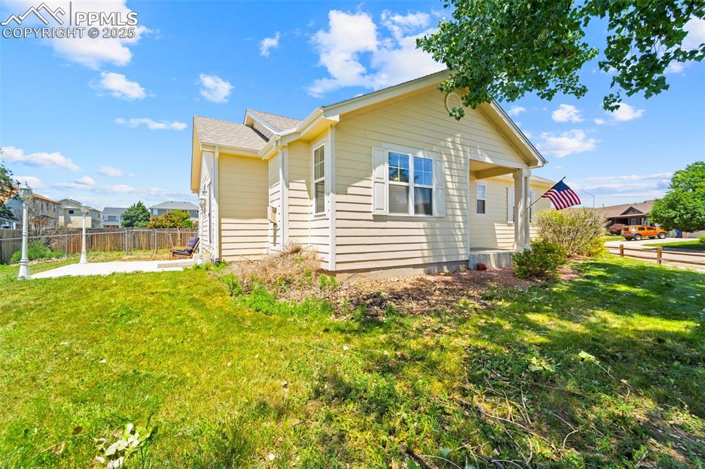 6963 Maram Way Fountain, CO 80817 - Photo 4 of 22 a front view of a house with a garden