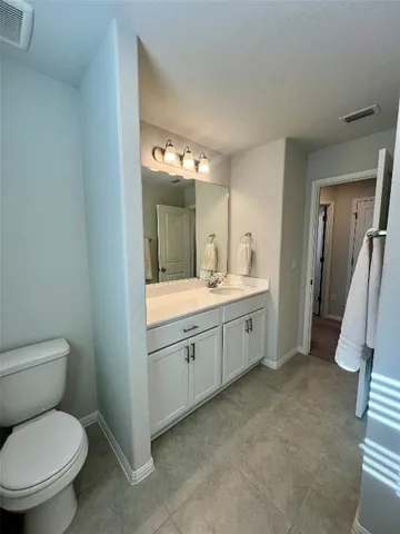a bathroom with a double vanity sink and a toilet