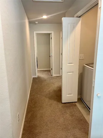 an empty room with closet and mirror