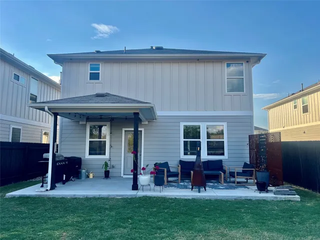 a view of a porch with chairs and a table