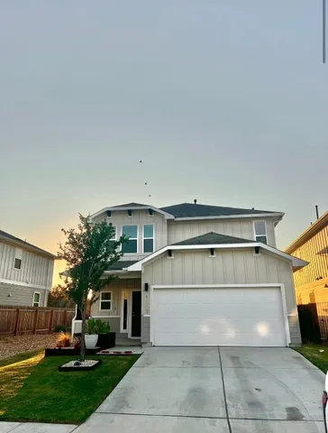 a view of a house with a large window and yard