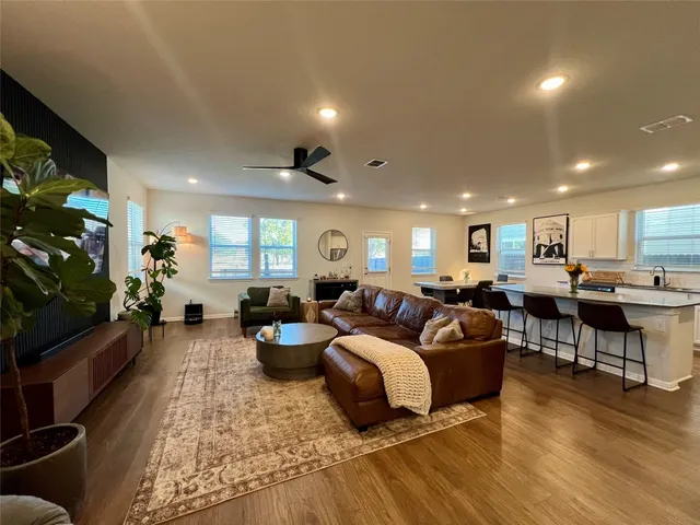 a living room with lots of furniture and a flat screen tv