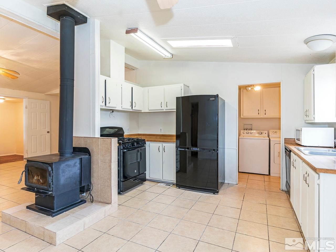 3935 Brant Street Reno, NV 89508 - Photo 6 of 15 a kitchen with a refrigerator sink and cabinets