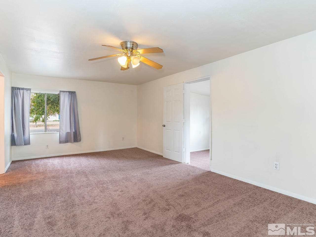 3935 Brant Street Reno, NV 89508 - Photo 7 of 15 an empty room with windows and chandelier fan