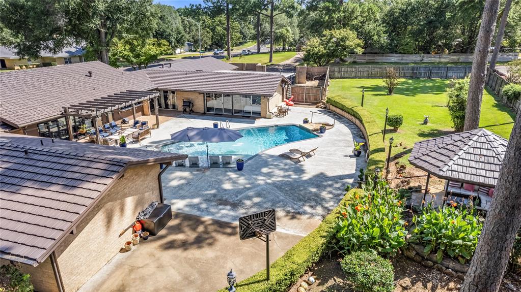 1300 Montclair Street Longview, TX 75601 - Photo 32 of 39 View of swimming pool featuring a pergola, a fenced backyard, a patio area, and view of scattered trees