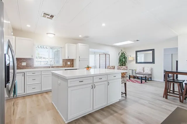 a kitchen with a sink cabinets and window
