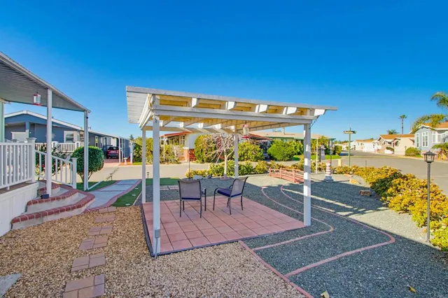 a view of a patio with a table and chairs
