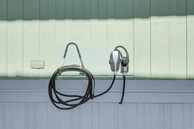a front view of a house with a yard and potted plants
