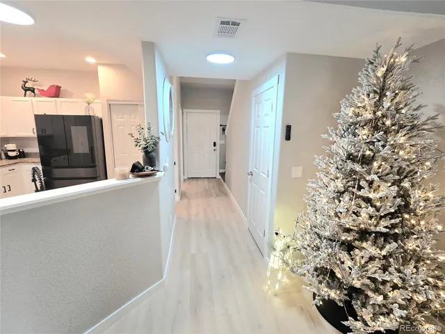 a kitchen with stainless steel appliances kitchen island granite countertop a refrigerator oven a sink and dishwasher