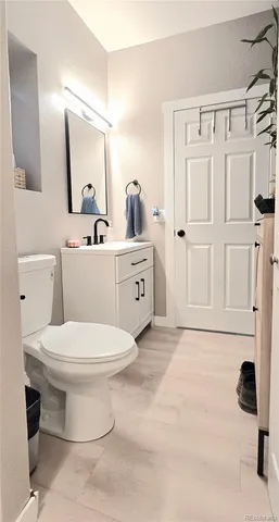 a bathroom with a toilet sink and mirror
