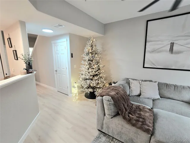 a living room with furniture and a chandelier