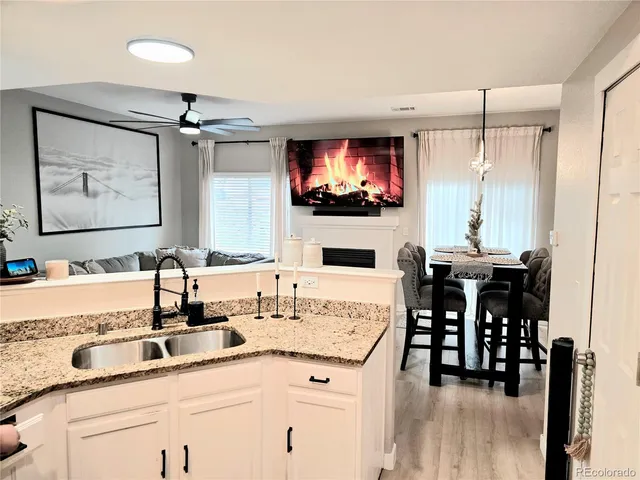a kitchen with stainless steel appliances kitchen island granite countertop a sink and cabinets