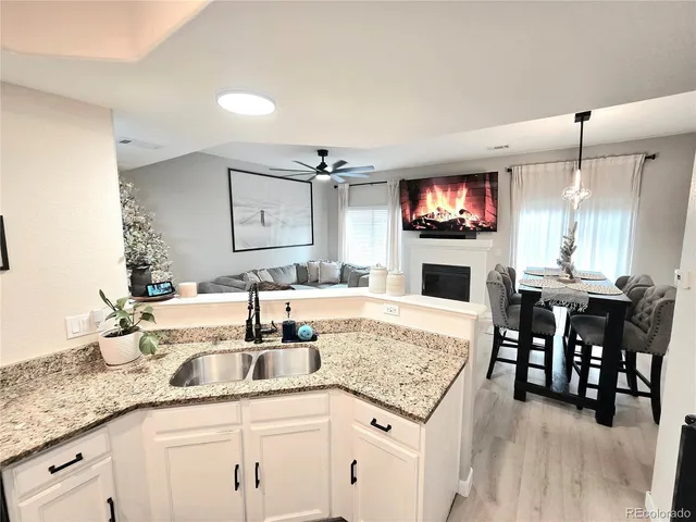a kitchen with kitchen island granite countertop a sink a counter top space and appliances