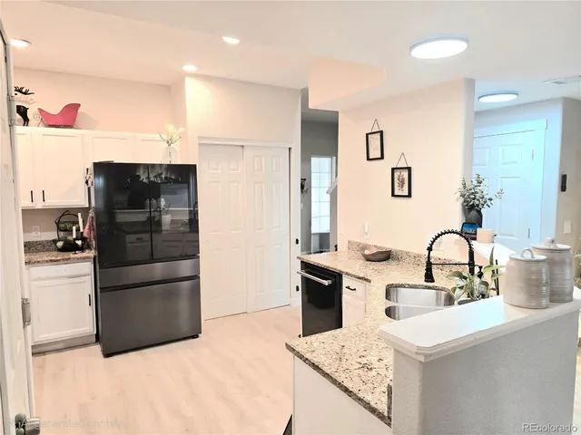 a kitchen with a refrigerator and a sink