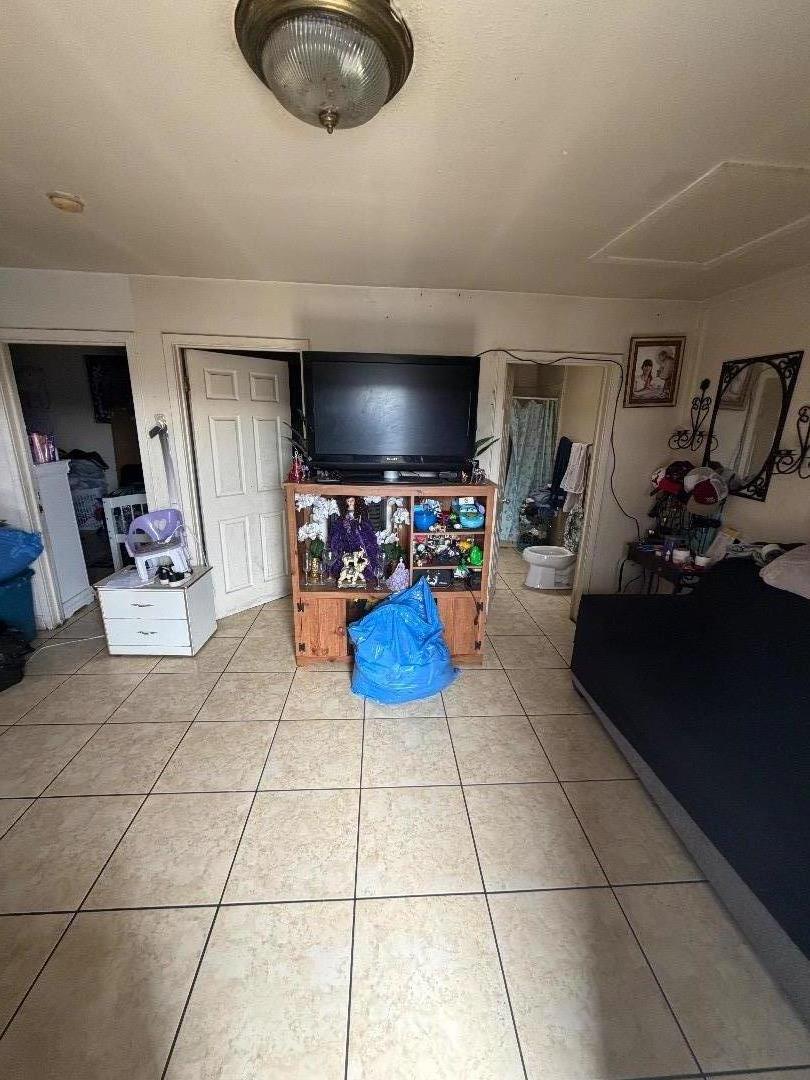 615 Terrace Street Salinas, CA 93905 - Photo 6 of 7 a living room with furniture a flat screen tv and gym equipment