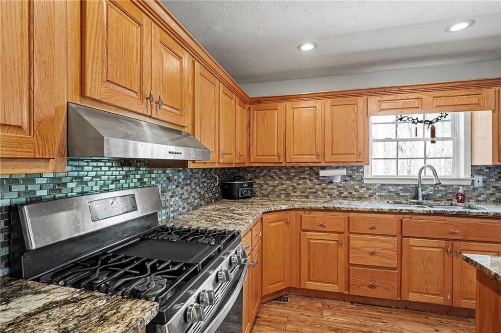 526 Antioch Church Road Talking Rock, GA 30175 - Photo 11 of 38 a kitchen with granite countertop a stove sink and cabinets