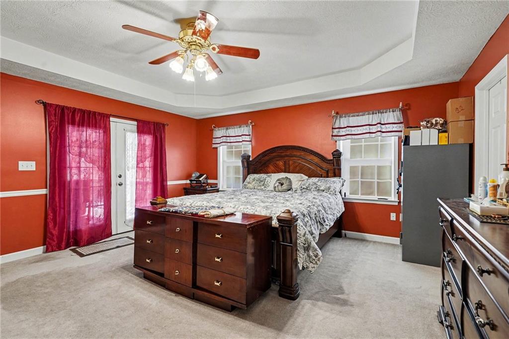 526 Antioch Church Road Talking Rock, GA 30175 - Photo 18 of 38 a bedroom with a bed and a chandelier