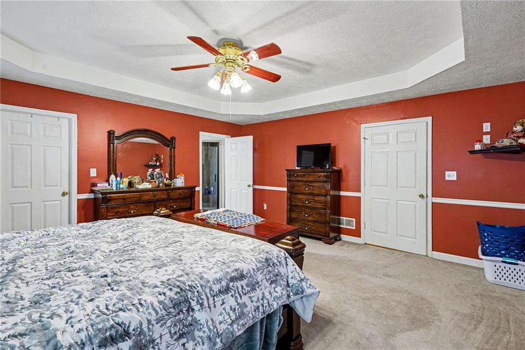 526 Antioch Church Road Talking Rock, GA 30175 - Photo 19 of 38 a bedroom with a bed and dresser with mirror
