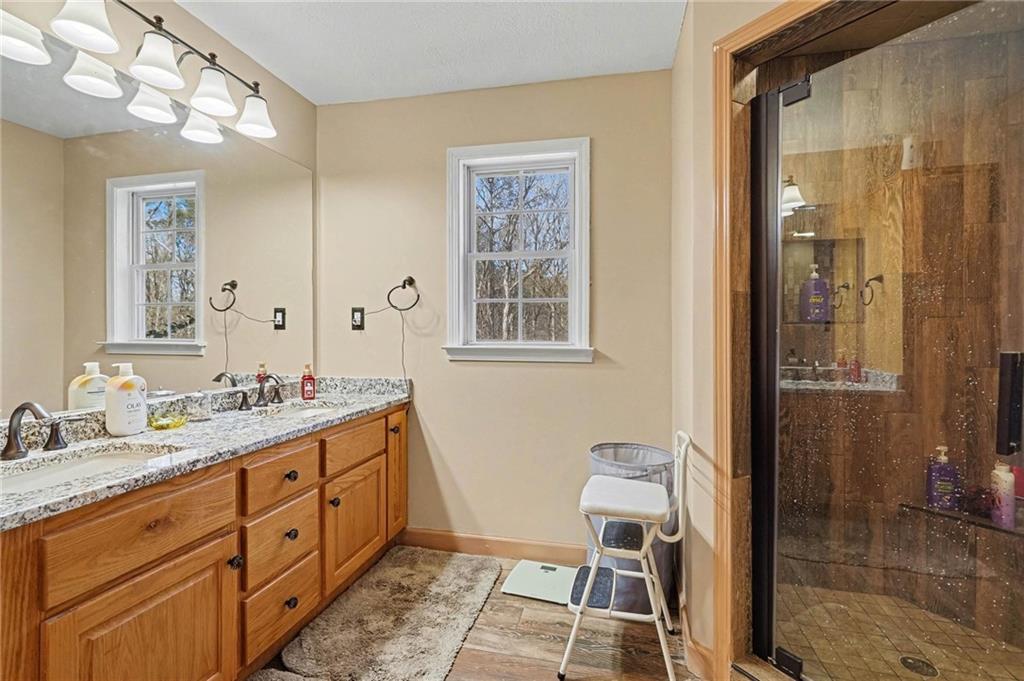 526 Antioch Church Road Talking Rock, GA 30175 - Photo 20 of 38 a spacious bathroom with a double vanity sink a mirror and a shower