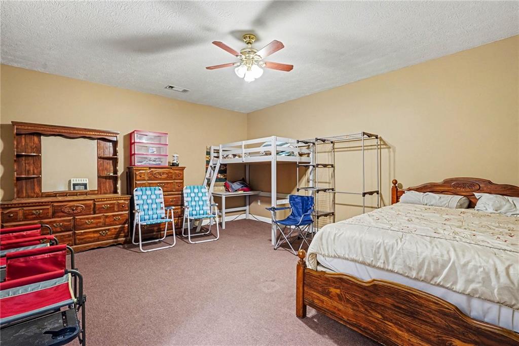 526 Antioch Church Road Talking Rock, GA 30175 - Photo 25 of 38 a bedroom with a bed a desk and chair