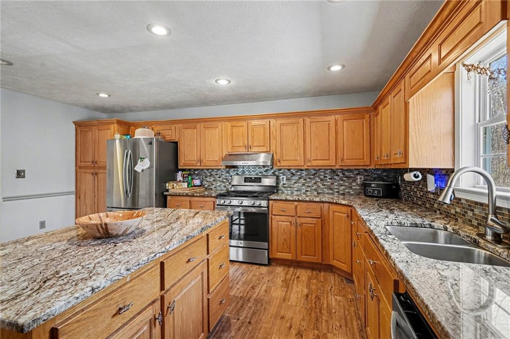 526 Antioch Church Road Talking Rock, GA 30175 - Photo 10 of 38 a kitchen with stainless steel appliances granite countertop sink stove top oven and refrigerator