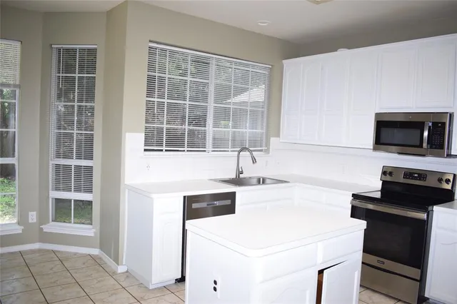 a kitchen with a sink and a stove top oven