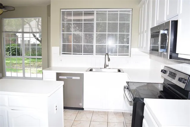 a kitchen with a stove a sink and a refrigerator