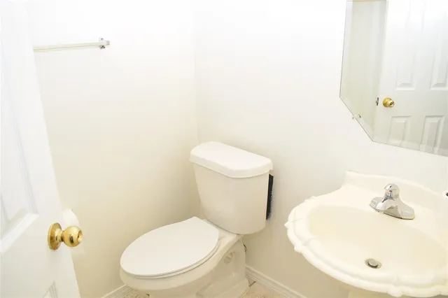 a white toilet sitting next to a bathroom sink