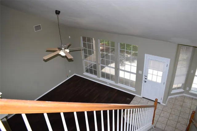a view of wooden floor and a chandelier in a room